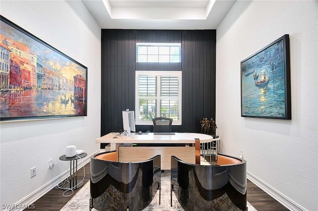 office space with a raised ceiling and dark hardwood / wood-style flooring