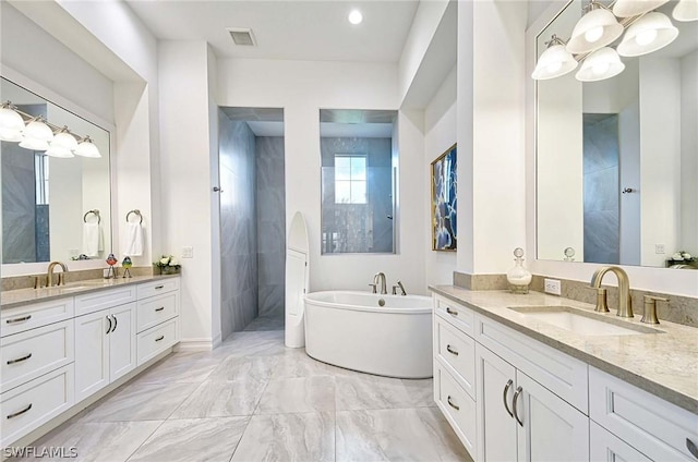 bathroom with vanity and independent shower and bath