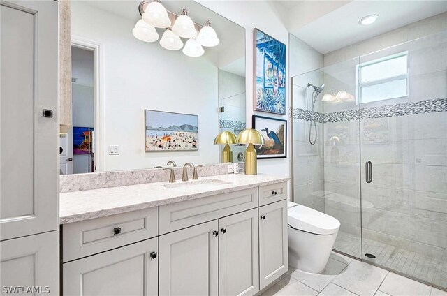 bathroom featuring tile patterned flooring, vanity, an enclosed shower, and toilet