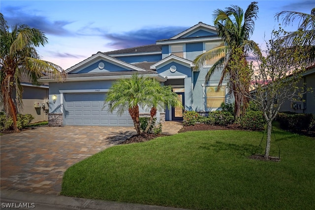 view of front facade featuring a lawn and a garage