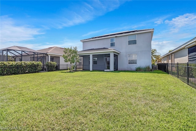 rear view of property featuring a lawn and a sunroom