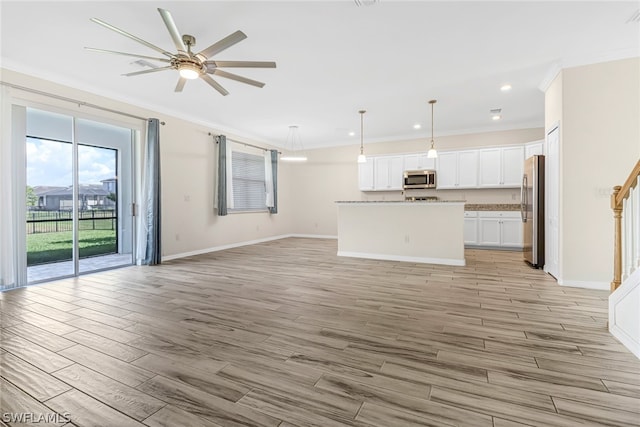 unfurnished living room featuring ceiling fan, crown molding, and light hardwood / wood-style floors