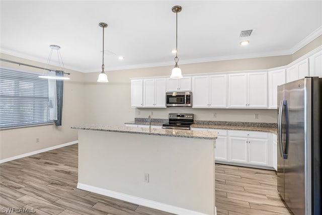 kitchen featuring light wood-type flooring, stainless steel appliances, pendant lighting, a center island with sink, and white cabinetry