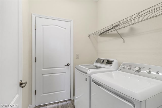 laundry area featuring dark hardwood / wood-style flooring and washer and dryer