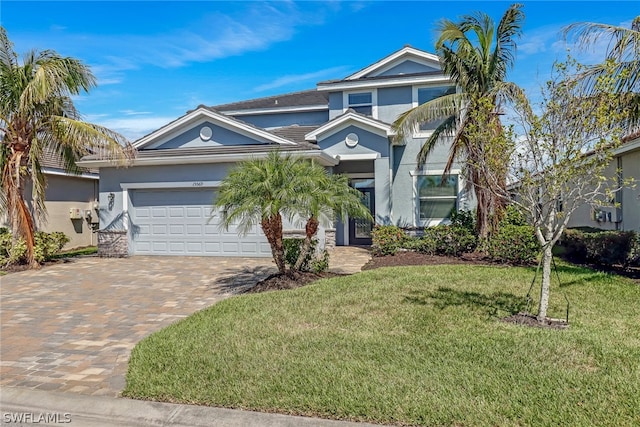 view of front of home with a front lawn and a garage