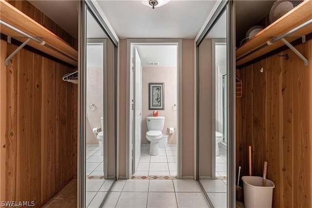 interior space featuring tile patterned floors and toilet