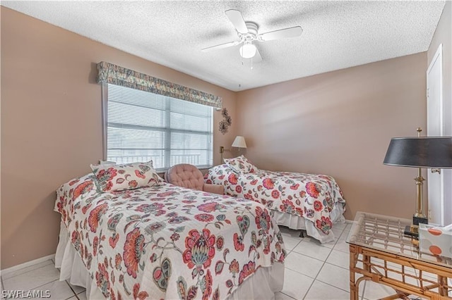 bedroom with light tile patterned flooring, ceiling fan, and a textured ceiling