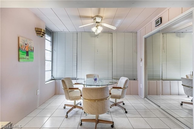 dining space featuring ceiling fan and light tile patterned floors