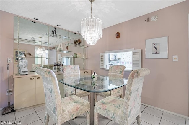 dining room with light tile patterned floors and a notable chandelier