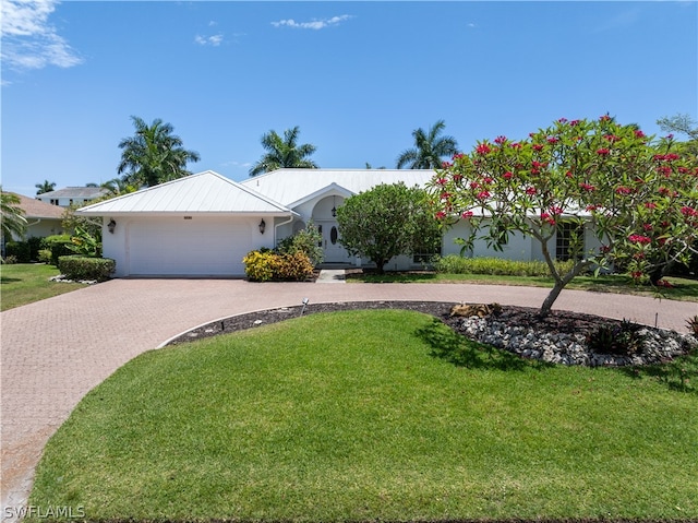 ranch-style house with a garage and a front lawn