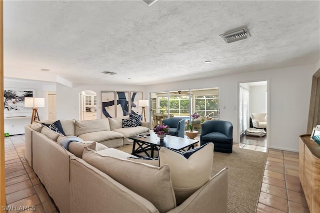 living room featuring light tile patterned floors and a textured ceiling