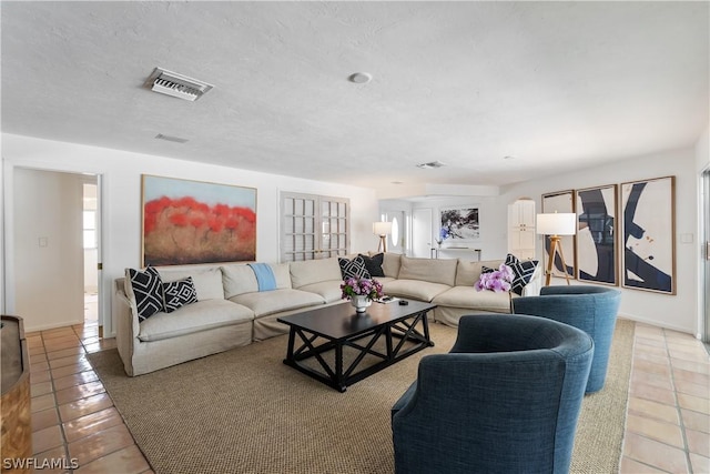 tiled living room with a textured ceiling