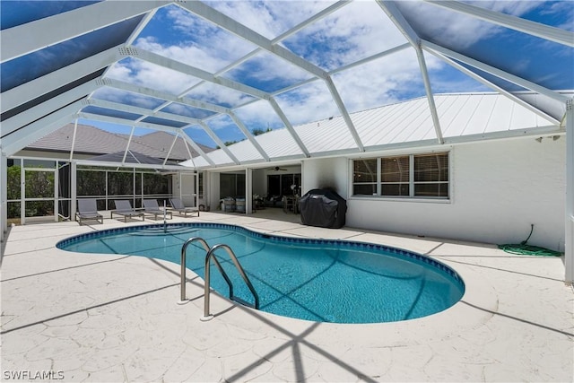 view of pool featuring a grill, a patio, and glass enclosure