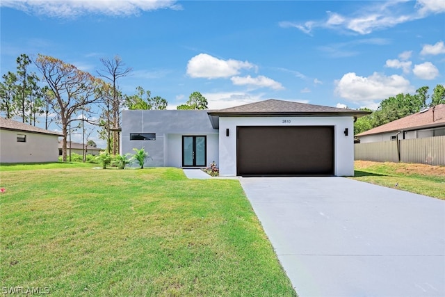 view of front of home with a garage and a front yard