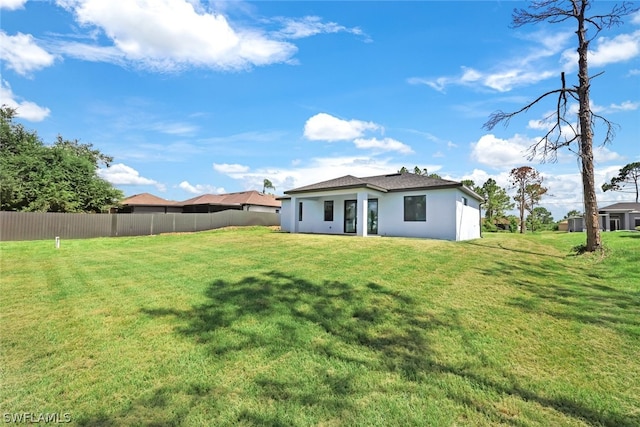 back of house with a yard