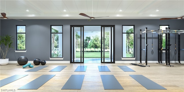 exercise room featuring ceiling fan and light wood-type flooring