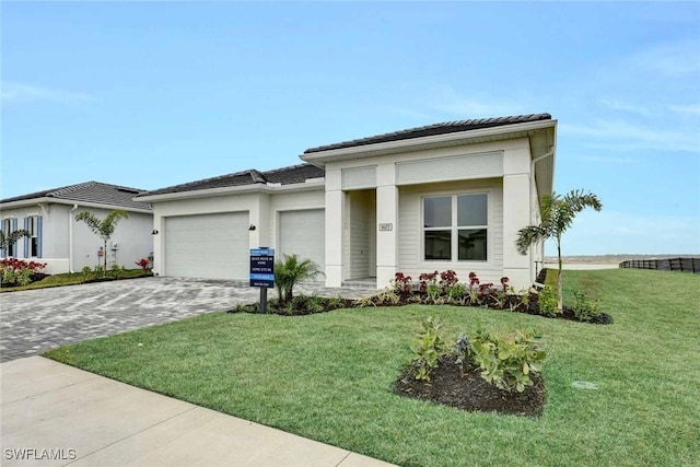 view of front of house featuring a garage and a front yard