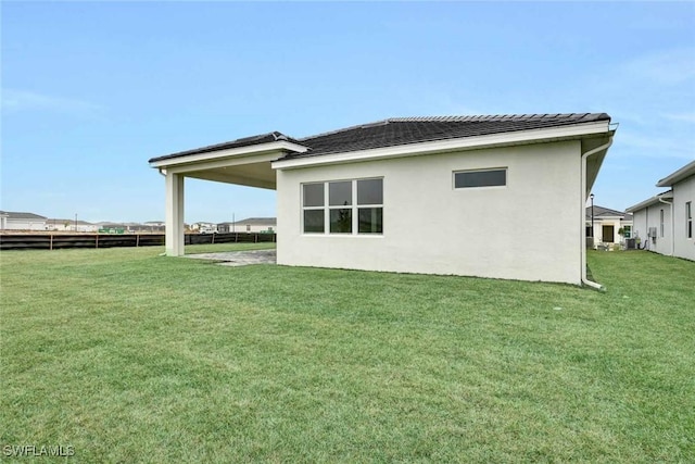 rear view of house with a yard