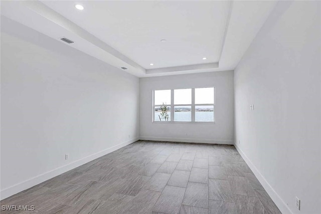 empty room featuring a tray ceiling