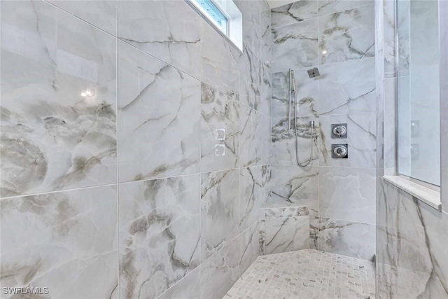 bathroom with a tile shower