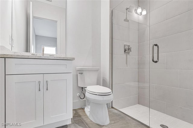 bathroom with vanity, toilet, and a shower with shower door