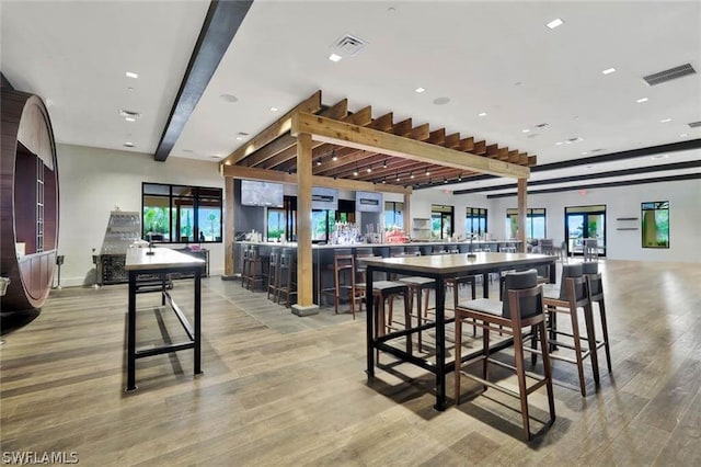 dining area with visible vents and light wood-style flooring