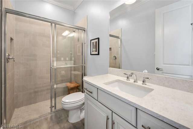 full bath with a stall shower, toilet, crown molding, and vanity