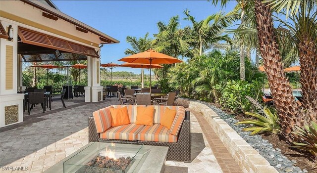 view of patio featuring an outdoor living space with a fire pit and outdoor dining area