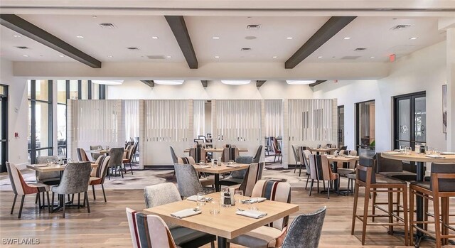 dining room featuring beamed ceiling, recessed lighting, light wood-style floors, and visible vents