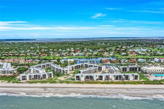 drone / aerial view with a water view and a beach view