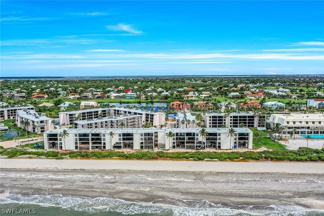 drone / aerial view with a water view and a view of the beach