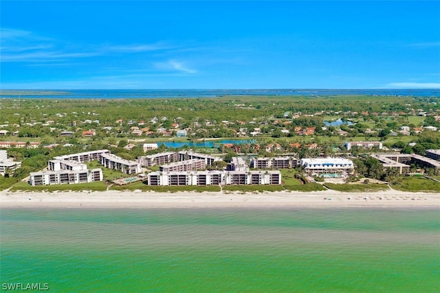 birds eye view of property featuring a water view and a beach view