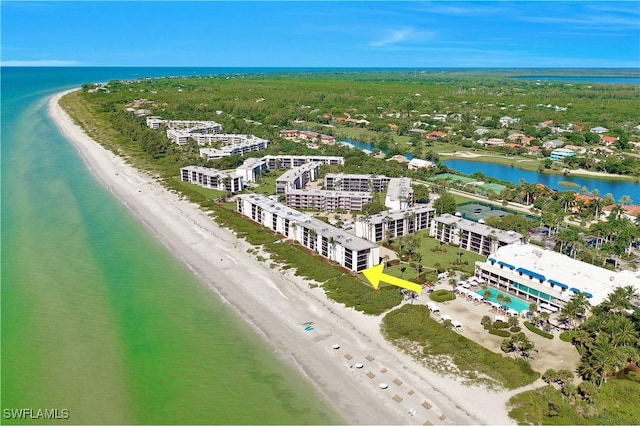 drone / aerial view featuring a water view and a view of the beach