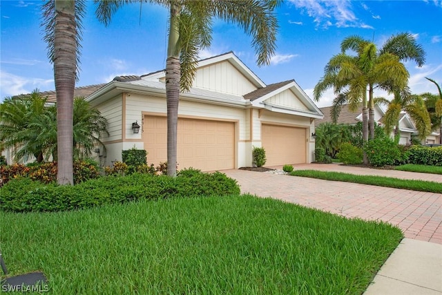 view of front facade with a front yard and a garage