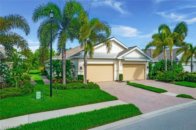 view of front of home with a garage and a front lawn