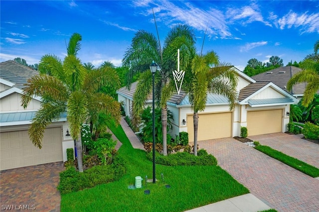 view of front of home with a garage and a front lawn