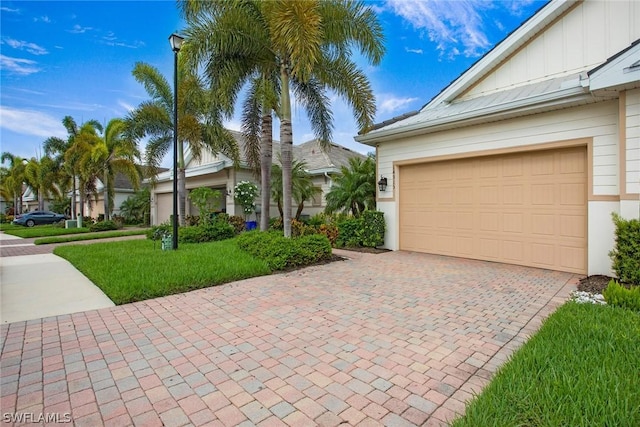 view of front of property with a garage and a front lawn