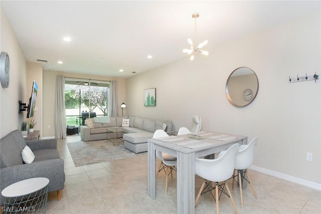 dining space with light tile patterned floors and an inviting chandelier