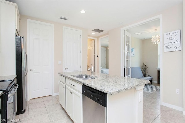 kitchen with appliances with stainless steel finishes, sink, light tile patterned floors, a center island with sink, and white cabinetry