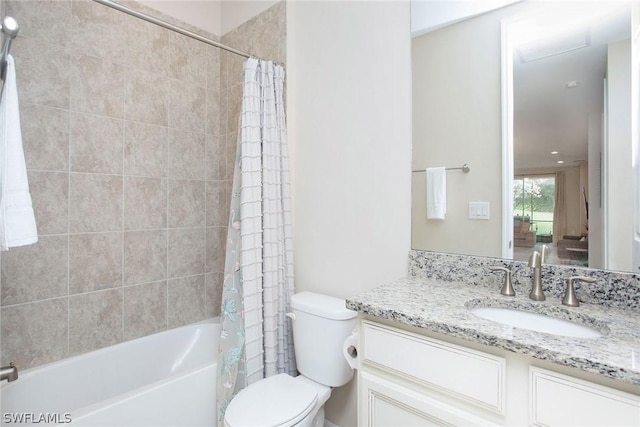 full bathroom featuring vanity, shower / bath combination with curtain, and toilet