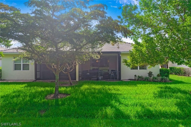 back of house with a lawn