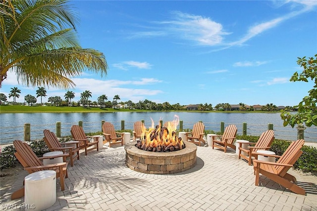 view of patio / terrace featuring a water view and an outdoor fire pit