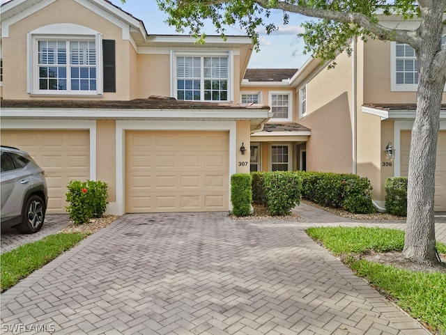 townhome / multi-family property featuring a garage