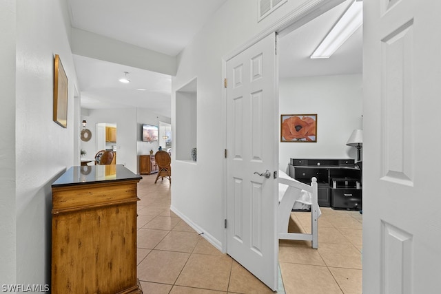 hall with tile floors