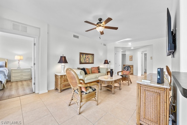 living room featuring ceiling fan and light tile floors