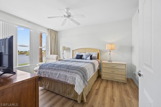 bedroom with ceiling fan and light hardwood / wood-style floors