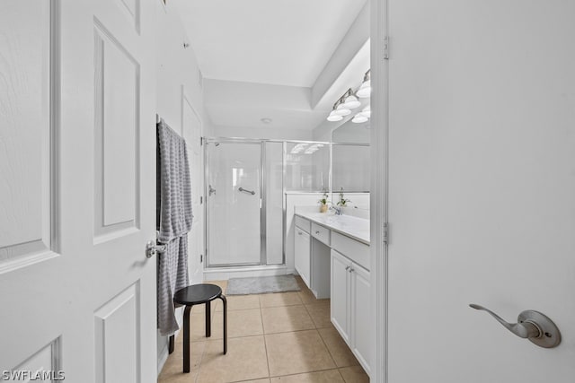 bathroom with tile flooring, walk in shower, and vanity