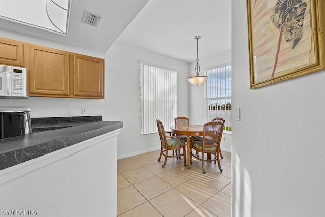 kitchen featuring light tile floors and pendant lighting