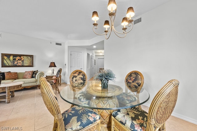 dining area with light tile floors and an inviting chandelier