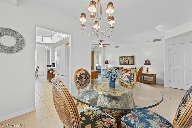 dining space featuring ceiling fan with notable chandelier and light tile floors